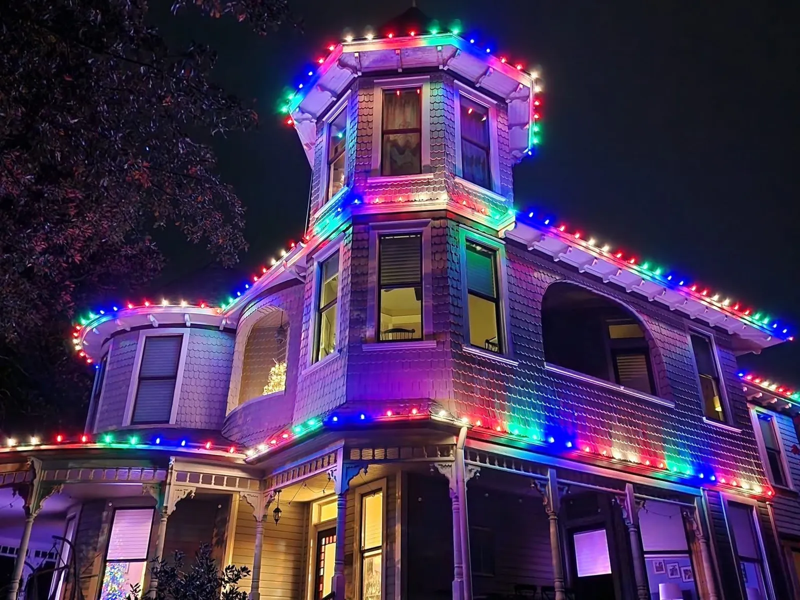 The Victorian house once more, in green, blue and red, lit to the top of the turret