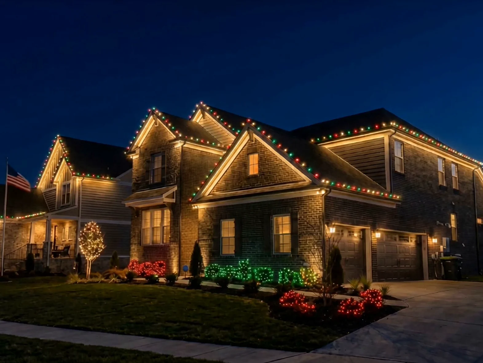 A house at night with warm white lights running the full length of the roofline